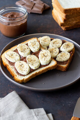 Sandwich with chocolate paste, banana and chia seeds. Breakfast. Vegetarian food.