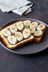 Sandwich with chocolate paste, banana and chia seeds. Breakfast. Vegetarian food.