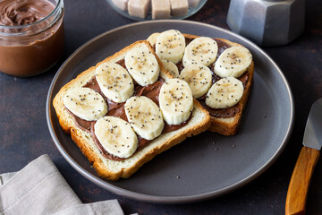 Sandwich with chocolate paste, banana and chia seeds. Breakfast. Vegetarian food.