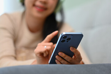 Happy young woman texting messaging on smartphone. Lifestyle, communicating and technology concept