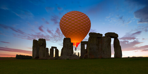 Panoramic view of Stonehenge at cloudy sky with hot air balloon - United Kingdom