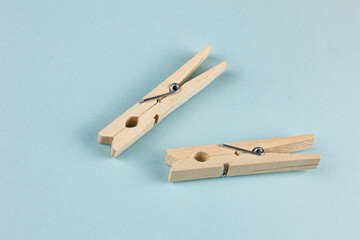 Top View of Two Natural Wooden Clothespins on Blue Background: Eco-Friendly Minimalistic Flat Lay Design with Copy Space
