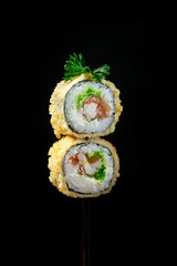 Sushi rolls on a bamboo stick, dark background