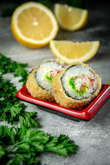 Sushi rolls with greens in a red sauce pot