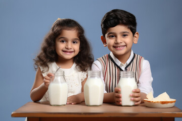 Indian little siblings drinking milk in glass
