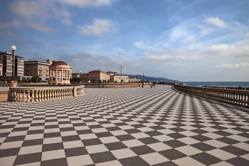 Foto op Plexiglas Leghorn (Livorno), Tuscany, Italy: landscape of the promenade Mascagni Terrace, a picturesque seashore on the Ligurian sea with black and white checkered pavement and columned bannister © ermess
