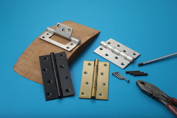 Installation of furniture hinges in chipboard. Small carpentry work in the workshop. light background,Installation of furniture hinges in chipboard in the workshop.dark background