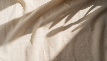 Aesthetic natural textile background with abstract sunlight shadow, neutral beige linen draped...