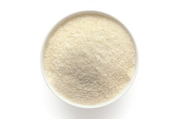 Bowl of organic Rice Flour (Oryza sativa) isolated on a white background, top view.