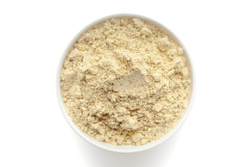 Bowl of organic Chickpea Flour (Cicer arietinum) or Gram Flour isolated on a white background, top view.