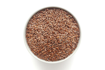 Organic Flaxseeds (Linum usitatissimum) in a white ceramic bowl. Isolated on a white background. Top View