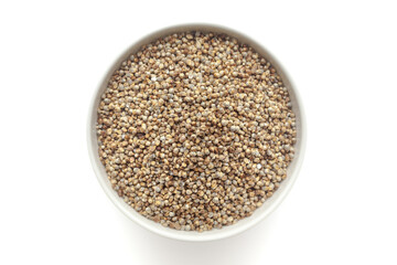 Organic Pearl Millet (Pennisetum glaucum) or Bajra in a white ceramic bowl. Isolated on a white background. Top View
