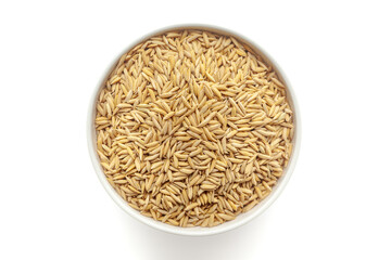 Organic Rice with Bran (Oryza sativa) or Dhaan in a white ceramic bowl. Isolated on a white background. Top View.