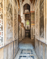 Fototapeta na wymiar Narrow hallway with decorated marble walls in the Qalawun Complex, a historic Islamic complex located on Moez Street in Cairo, Egypt