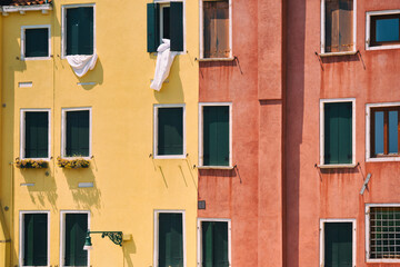Close up detail with old medieval architecture venetian window. Colorful buildings in Italy.