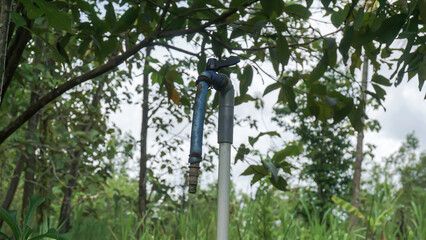 Obraz premium Water faucet in the garden with nature background, Indonesia.