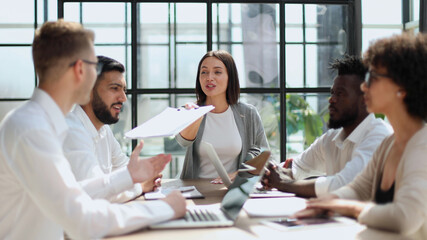 Fototapeta premium Employees working at computer together, discussing content