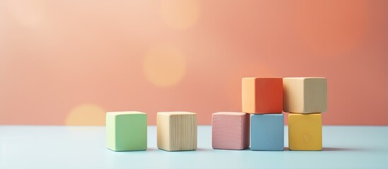 Wooden blocks in geometric shapes for toddlers isolated on a isolated pastel background Copy space - obrazy, fototapety, plakaty
