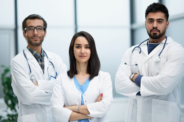 Fototapeta premium Three medical colleagues stand in the lobby of the hospital