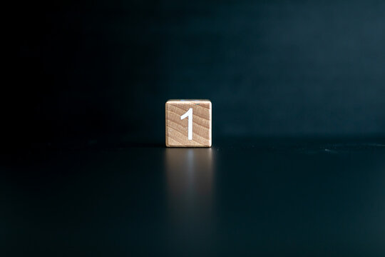 Wooden block written "1" with a Black background.