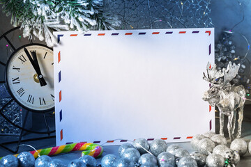 White empty envelope on a background of Christmas decorations, letter for Santa Claus, template for designer