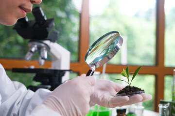 Scientist or student of biology researcher and scientist doing the biotechnology experiment in laboratory, scientist using microscope inspecting a science sampling. Plant lab chemical medicine.