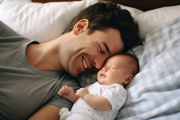 Father sleeping with baby on the bed 