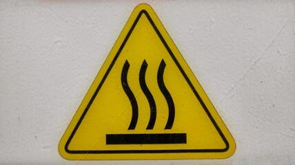 Hot surface sign sticker stick on the machine in production room of factory 