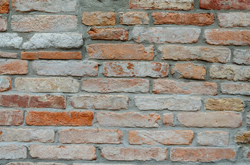 Grunge brick wall of an ancient Venetian building for your background. Italian architecture and heritage.