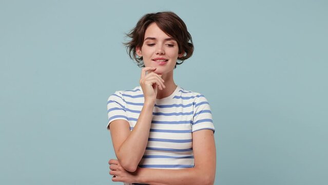 Excited smart proactive puzzled pensive young woman wear striped t-shirt casual clothes look around think scratche at temple comes up with idea raised finger get plan isolated on plain blue background