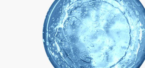 Transparent blue cosmetic gel in a round jar. View from above. On an light background.