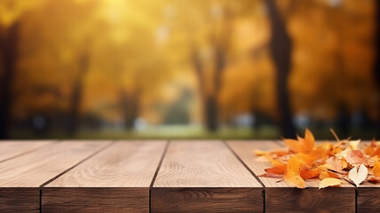 Naklejka na ściany i meble Fallen dry orange leaves on wooden boards against the backdrop of a blurry autumn park.