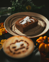 Spooky Brownie with ghost art and Halloween cappuccino coffee with a scary spooky pumpkin latte art and decorations