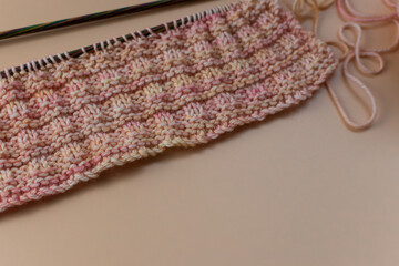 knitting background - a sample of hand knitting with knitting needles and copy space 