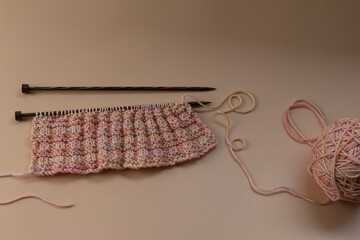 knitting background - a sample of hand knitting with knitting needles and copy space 
