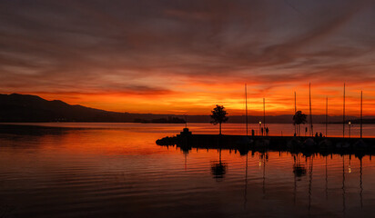 Fototapeta na wymiar Dramatic sunset on the shiores of the Zurich Lake, Rapperswil, St. Gallen, Switzerland