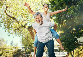 Fototapeta premium Couple, piggyback and nature to smile in portrait, excited and playful in freedom, energy and joy. Happy elderly asian people, face and date in summer, laughing and support for crazy in retirement