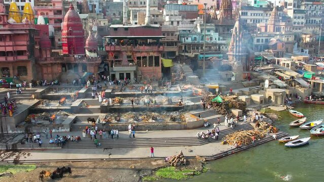 Fire Burial in Varanasi, India on Manikarnika ghat on Ganges River Drone 4K