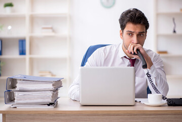 Young male employee working in the office