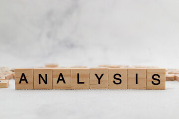 Top view of Analysis word on wooden cube letter block on white background. Business concept