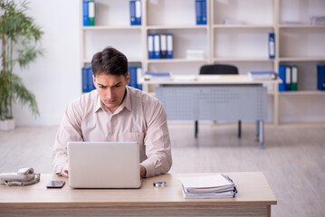 Young male employee working in the office