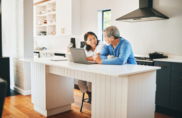 Mature couple, laptop and kitchen for home ideas, asset management and planning of finance or mortgage at home. Woman and man talking of insurance, investment and budget, cost or debt on computer