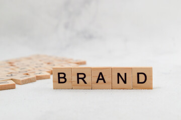 Top view of Brand word on wooden cube letter block on white background. Business concept