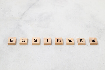 Top view of Business word on wooden cube letter block on white background. Business concept