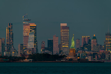 Cityscape landscape in blue hour about New York. included the Statue of liberty. Lady liberty is on the middle New York Skyscrapers is on the background included the famous Edge observation deck too © Geza Kurka