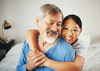 Happy senior couple, hug and love in bedroom for marriage, relationship or care together at home. Mature woman hugging man with smile in happiness for embrace, support or trust on bed in retirement