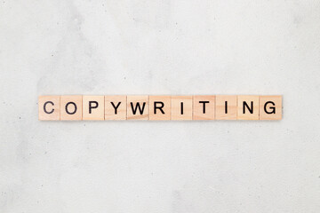Top view of Copywriting word on wooden cube letter block on white background. Business concept
