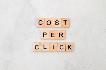 Top view of Cost Per Click word on wooden cube letter block on white background. Business concept