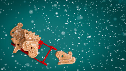 Gingerbread on turquoise background with snow. Christmas banner.Minimalism. Copyspace.