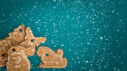 Gingerbread on turquoise background with snow. Christmas banner.Minimalism. Copyspace.